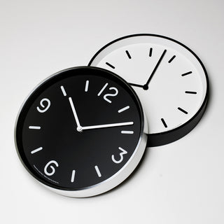 Pair of round wall clocks, black and white faces with white hour markers