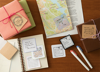 Paintable stamp book with ink pads, papers, and pens