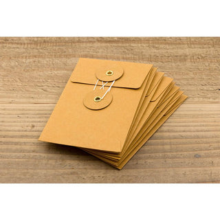 Stack of orange kraft envelopes with flap and two metal eyelet closures