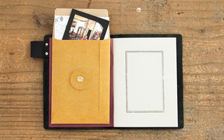 Orange kraft envelope with contents and visible inner card