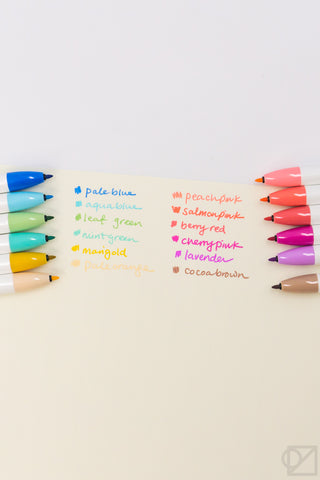 Retractable marker tips with pastel color name labels on the writing surface