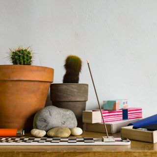 Sandalwood incense sticks set with small boxes and incense holder on tabletop