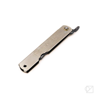 Chrome pocket knife close-up, straight blade with black pull tab and metal pin