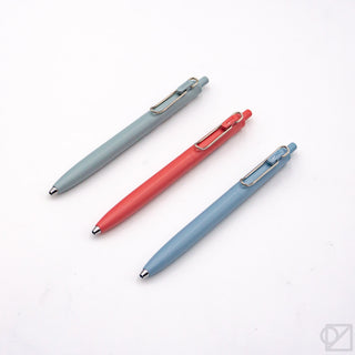 A set of three Uni-Ball One F 0.5mm Gel Pens in red, blue, and green colors, displayed on a white background.